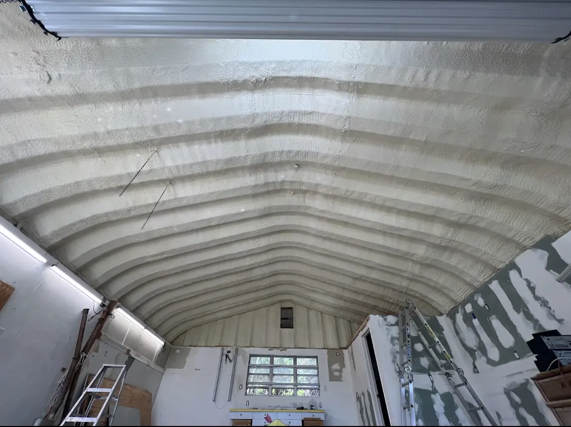 Spray polyurethane foam applied to the underside of a metal roof deck in El Campo